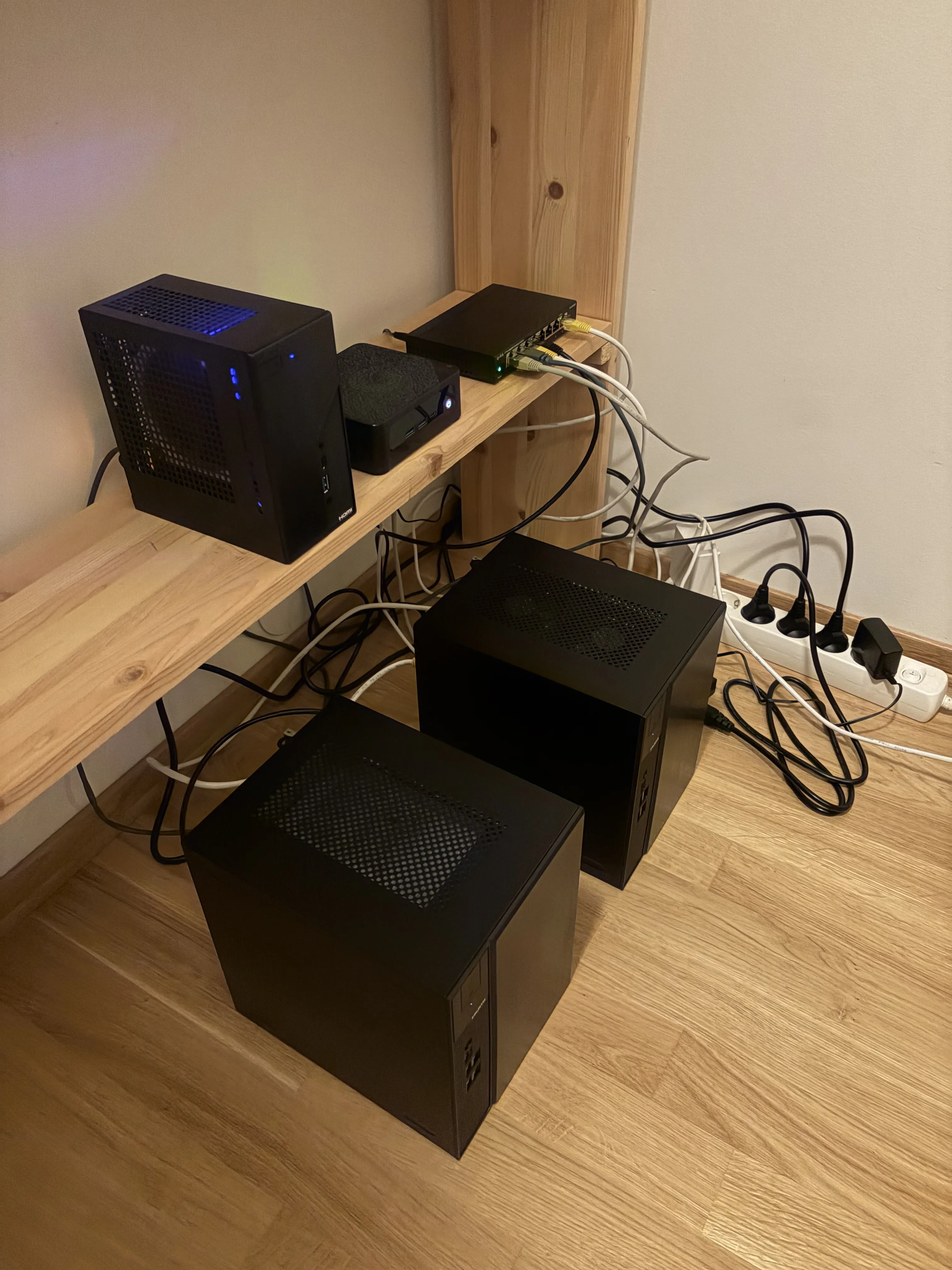 Home server setup with several compact computers, a network switch and connected cables